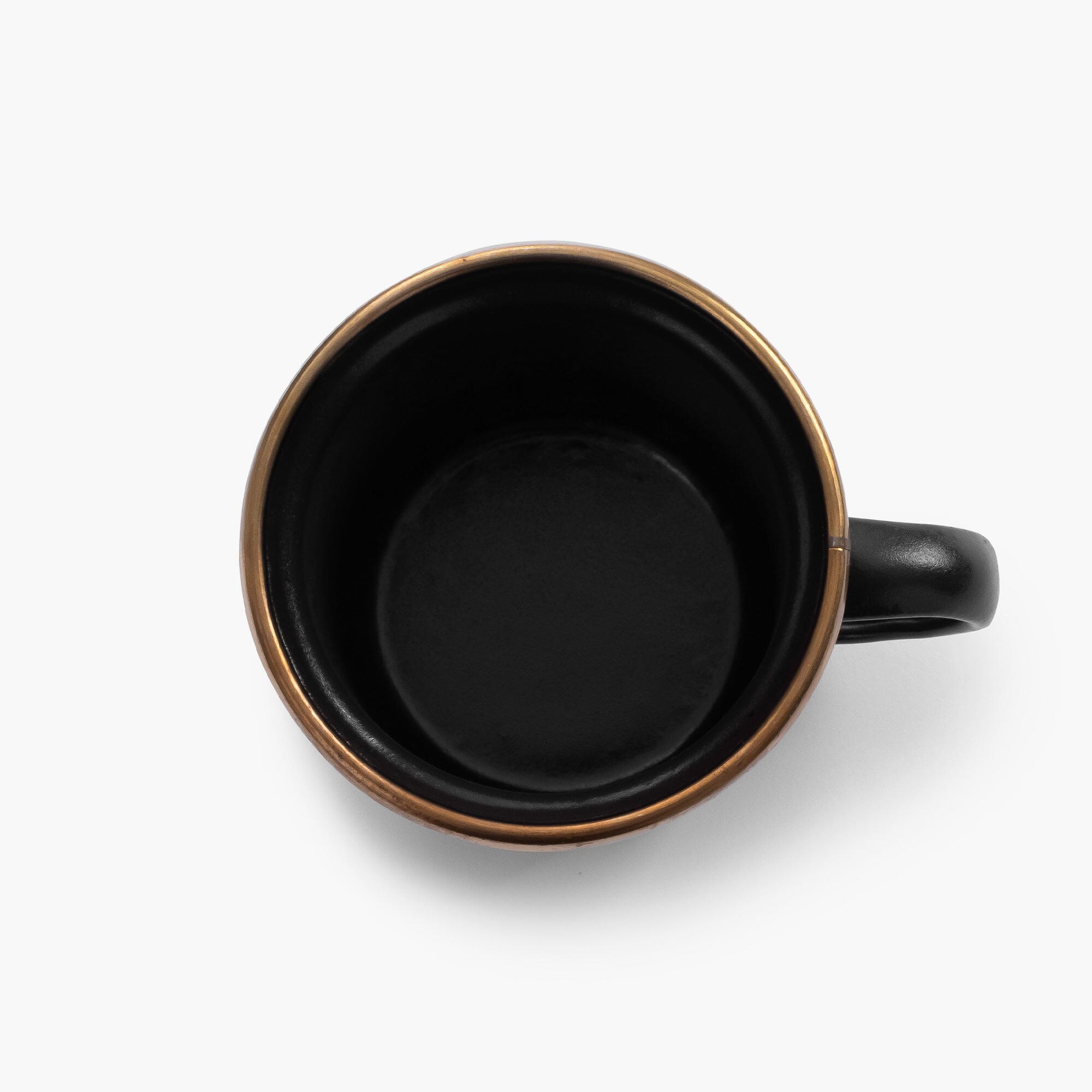 One black 5 oz enamel espresso cup with copper plated rim on viewed from above on a white background.