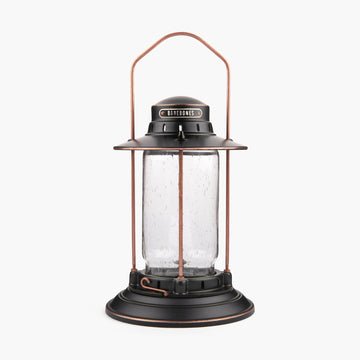 Barebones Vintage-style Hurricane Lantern with clear seaded glass and bronze metal accents on a white background